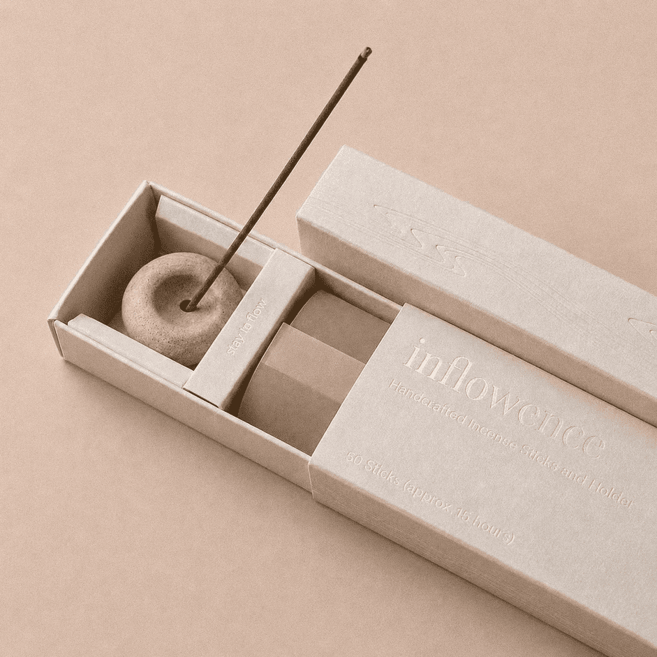Close-up of an open inflowence incense box with a ceramic holder and a lit incense stick on a red background.