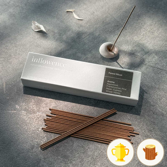 Forest Ritual handcrafted incense sticks by inflowence, shown with ceramic holder and minimal box packaging — a calming aroma blend of agarwood, frankincense, pine resin, cypress wood, and honey. A grounding ritual for meditation and clarity.