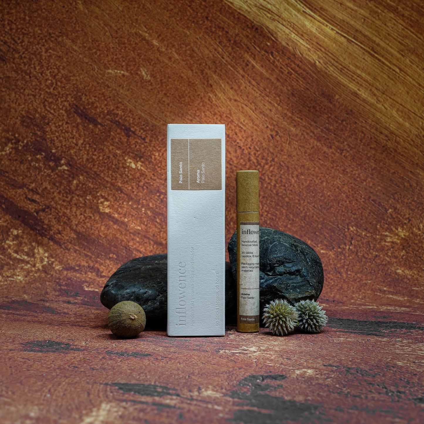 Palo Santo incense box and tube set displayed in front of a Grand Canyon-inspired oil painting backdrop, symbolizing spiritual cleansing and energy renewal with natural serenity and earthy calm.