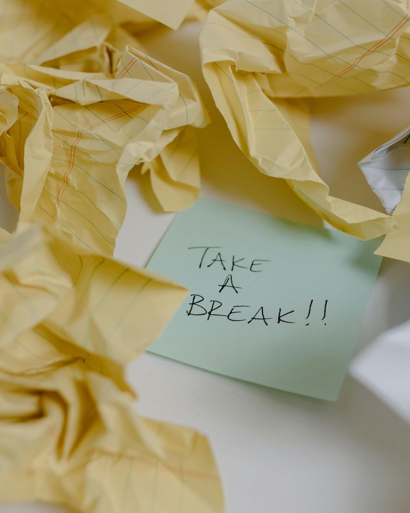 Handwritten note reading ‘Take a break’ on a sticky note, capturing nflowence’s message of slowing down and intentional pause.