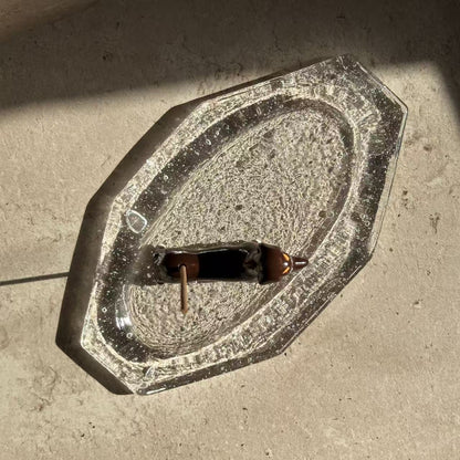 Ceramic dachshund incense holder placed on a handcrafted glass ash tray, holding an incense stick as a complete incense ritual setup