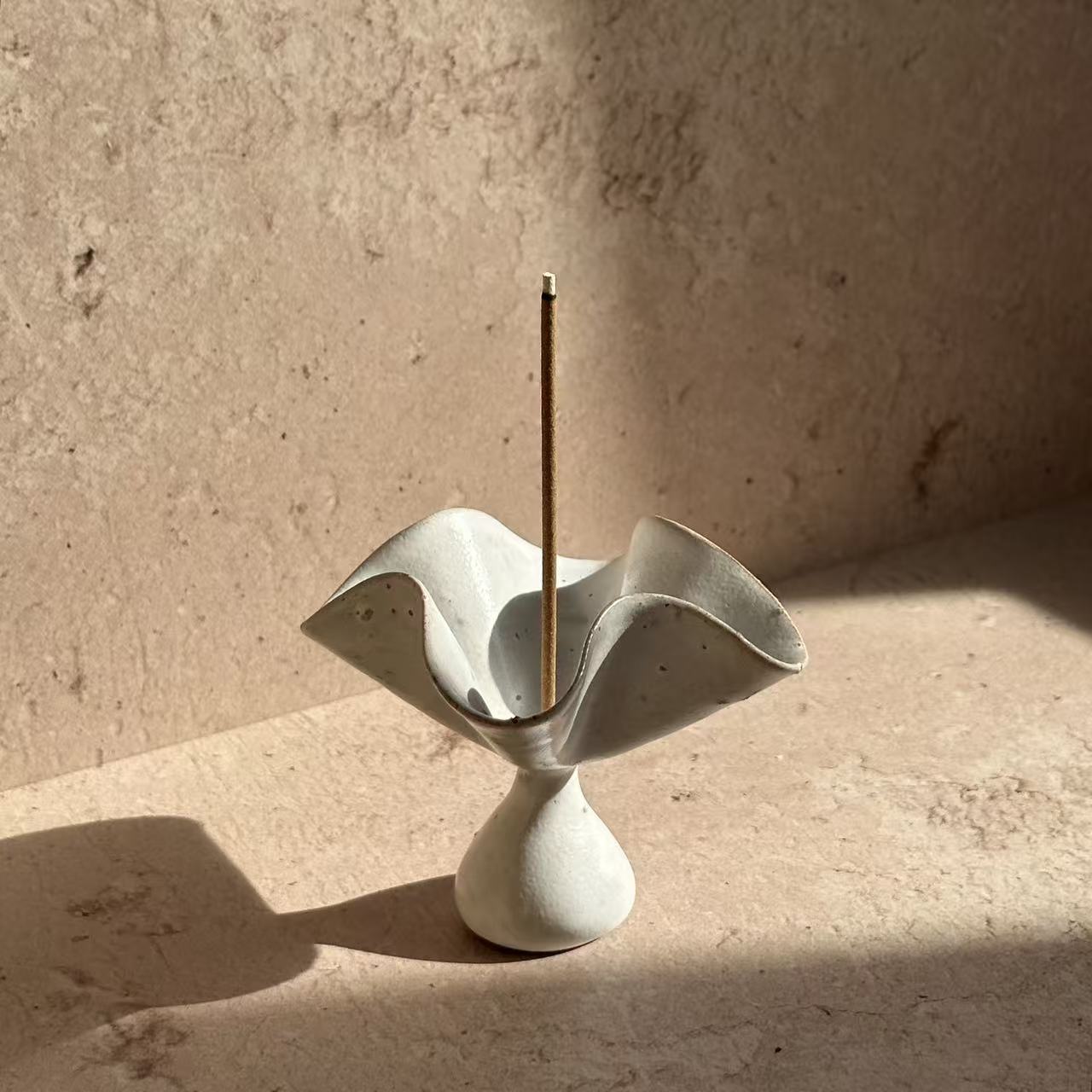 Ceramic petal incense holder with sculptural flower form, designed to hold incense sticks for modern ritual and mindful living