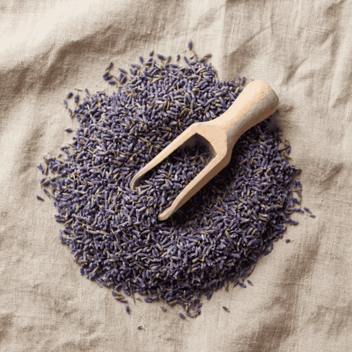 dried lavender buds piled on a linen surface with a small wooden scoop resting on top in soft natural light, a key ingredient used in inflowence lavender incense blends such as Deep Dream and Lavender Bliss