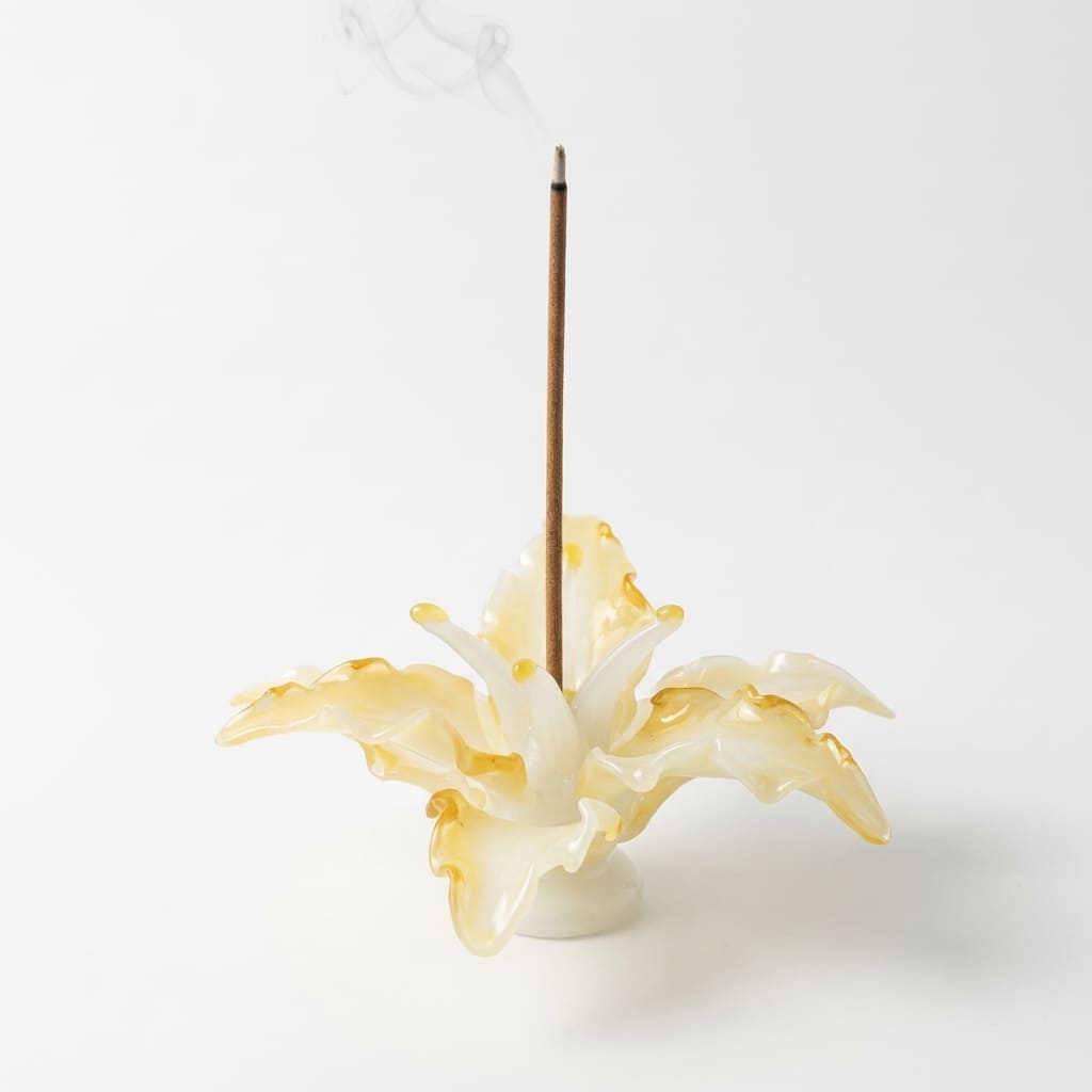 Lily Glass Incense Holder product shot on a clean white background, showing a handcrafted glass incense holder shaped like a blooming lily with a burning incense stick and naturally uneven petal edges.