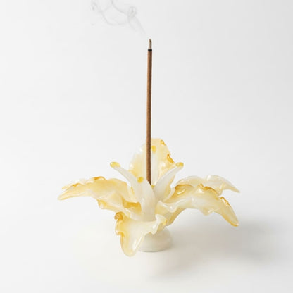 Lily Glass Incense Holder product shot on a clean white background, showing a handcrafted glass incense holder shaped like a blooming lily with a burning incense stick and naturally uneven petal edges.