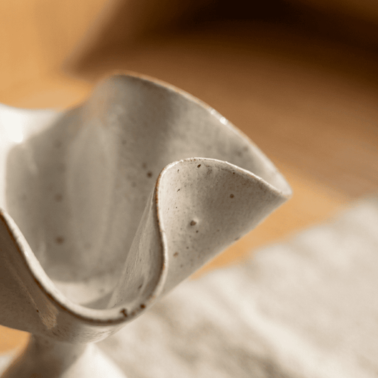 inflowence ceramic petal incense holder close-up showing textured, hand-formed surface in soft warm lighting