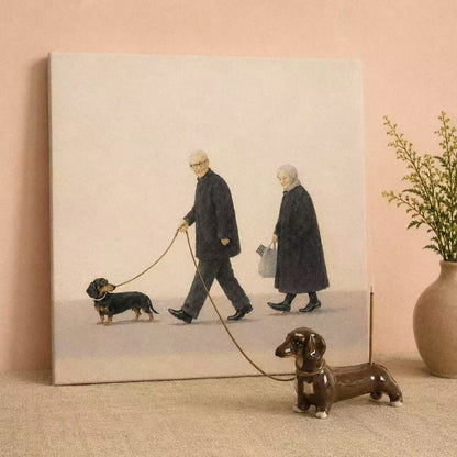 Sausage Dog Incense Holder shown as a hand-painted ceramic incense holder shaped like a dachshund, styled in front of a painting of an elderly couple walking a dachshund, with a leash extending from the artwork to the holder and a lit incense stick placed in its back.