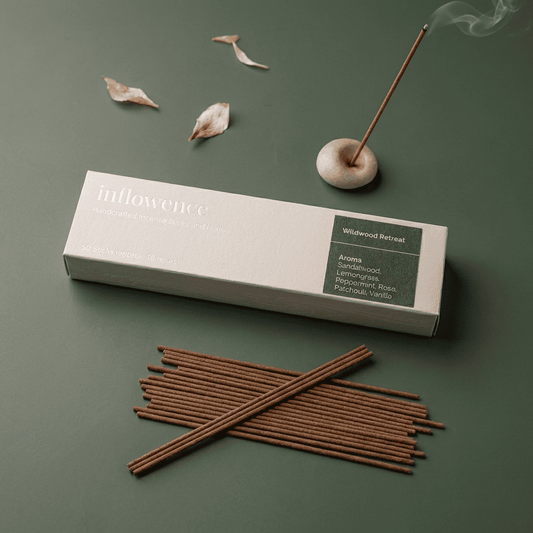 Patchouli incense sticks named ‘wildwood retreat’ packed in an incense box labeled 'inflowence' on a green background