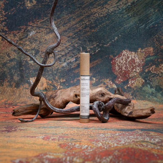 Forest Ritual incense tube styled with natural wood and branches, set against a green, red, and yellow oil painting–inspired backdrop — evoking a warm, earthy ritual atmosphere.