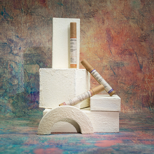 In Bloom Trio incense set displayed with white textured objects in front of a Monet-inspired canvas, blending soft elegance with artistic serenity.